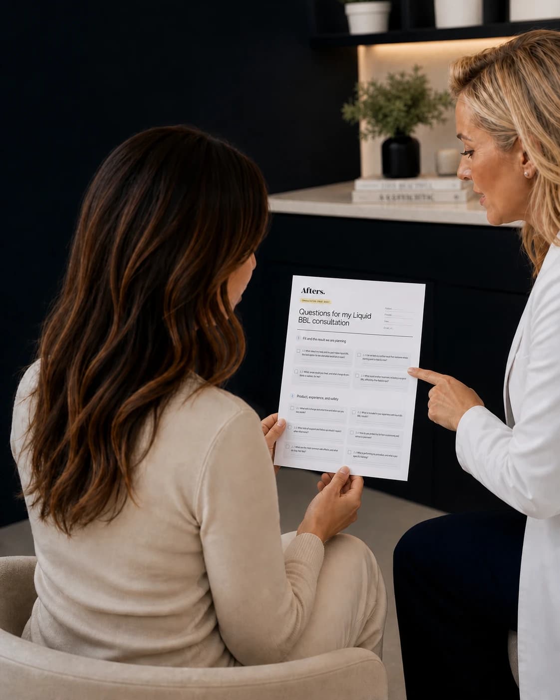Patient holding her Afters consultation guide while speaking with a cosmetic doctor